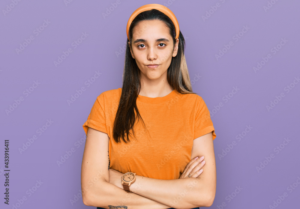 Obraz premium Young hispanic woman wearing casual clothes skeptic and nervous, disapproving expression on face with crossed arms. negative person.