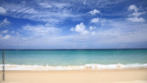 Sea of ​​Thailand, the tropical beaches of Phuket during the tourist season in Southern Thailand. The waves on the white sandy beach Beautiful sky and clouds on a sunny day Can see the horizon.