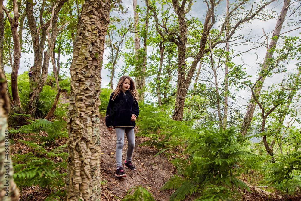 cute young girl running and jumping in a beautiful forest cute young girl running and jumping in a beautiful forest