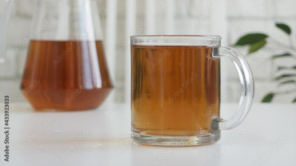 Man Hand Mixing Sugar in a Cup of Tea with a Teaspoon. Man Hand Mixing Sugar in a Cup of Tea with a Teaspoon.