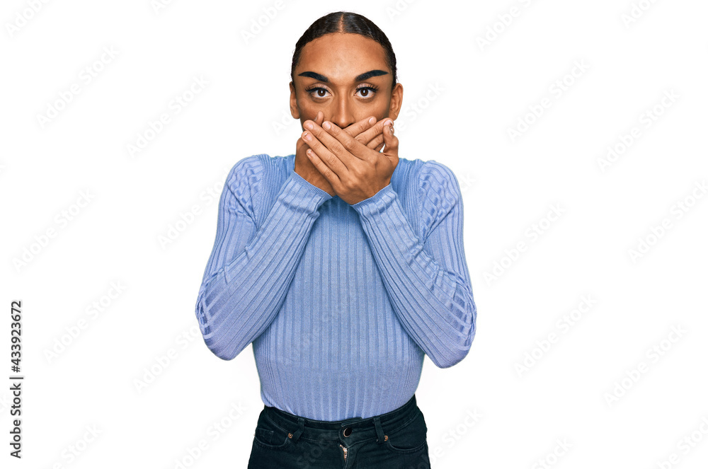 Hispanic transgender man wearing make up and long hair wearing casual clothes shocked covering mouth with hands for mistake. secret concept. Hispanic transgender man wearing make up and long hair wearing casual clothes shocked covering mouth with hands for mistake. secret concept.