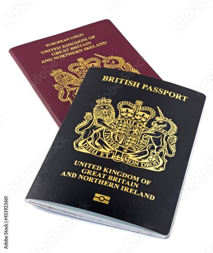A new black British non European passport with an old red type passport on a white background