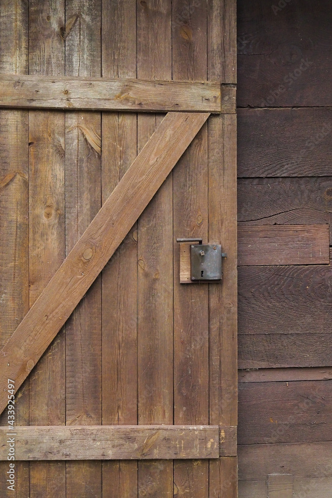 a wooden door and an old lock a wooden door and an old lock