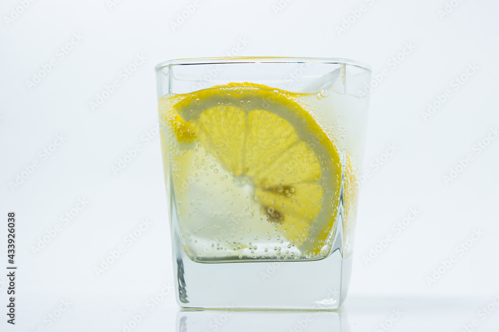 Lemon with ice in a glass. Refreshing drink with lemon. Cold cocktail Lemon with ice in a glass. Refreshing drink with lemon. Cold cocktail