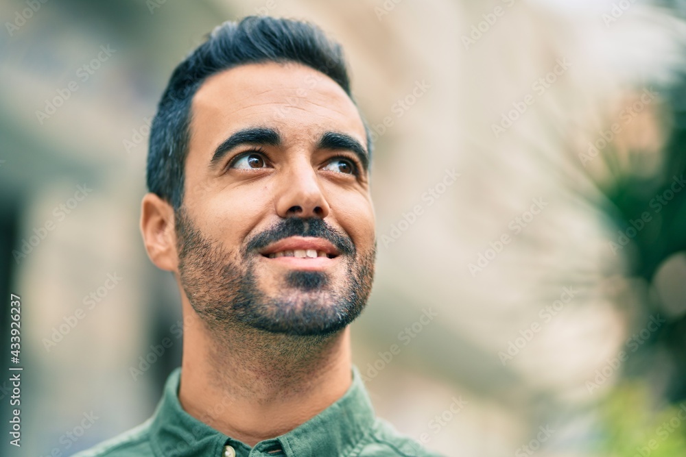 Young hispanic man smiling happy standing at the city. Young hispanic man smiling happy standing at the city.