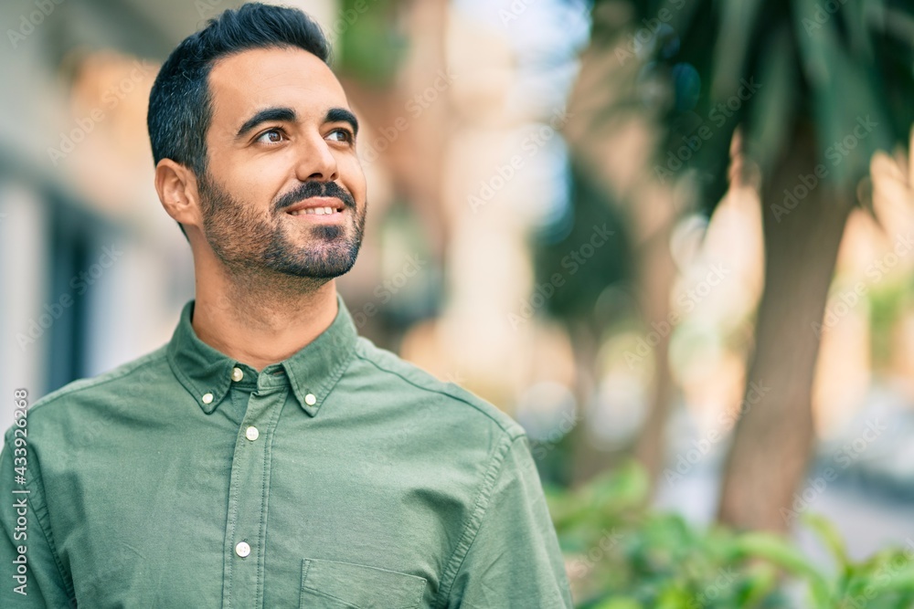 Young hispanic man smiling happy standing at the city. Young hispanic man smiling happy standing at the city.