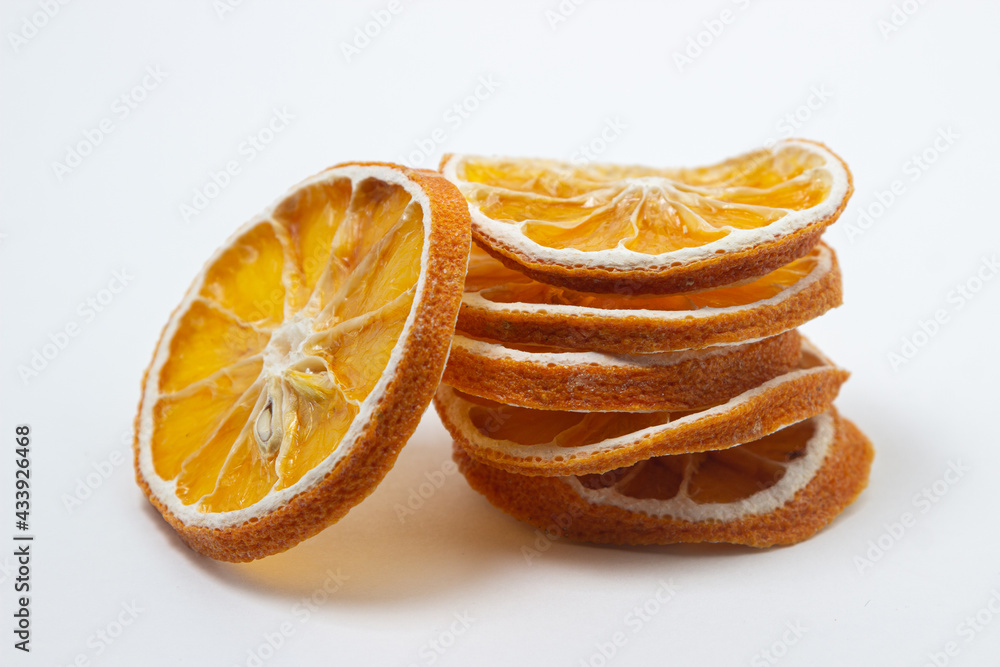 Dried orange on a white background. Round slices of dried orange. Dried fruit on a light background Dried orange on a white background. Round slices of dried orange. Dried fruit on a light background