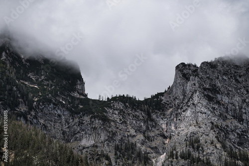 Dark mood - dramatic clouds and fogs over the mountains and parts with snow