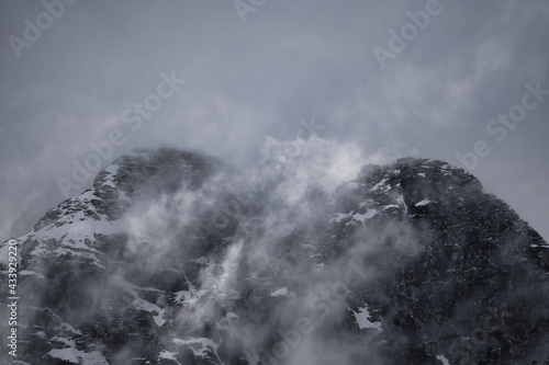 Dark mood - dramatic clouds and fogs over the mountains and parts with snow