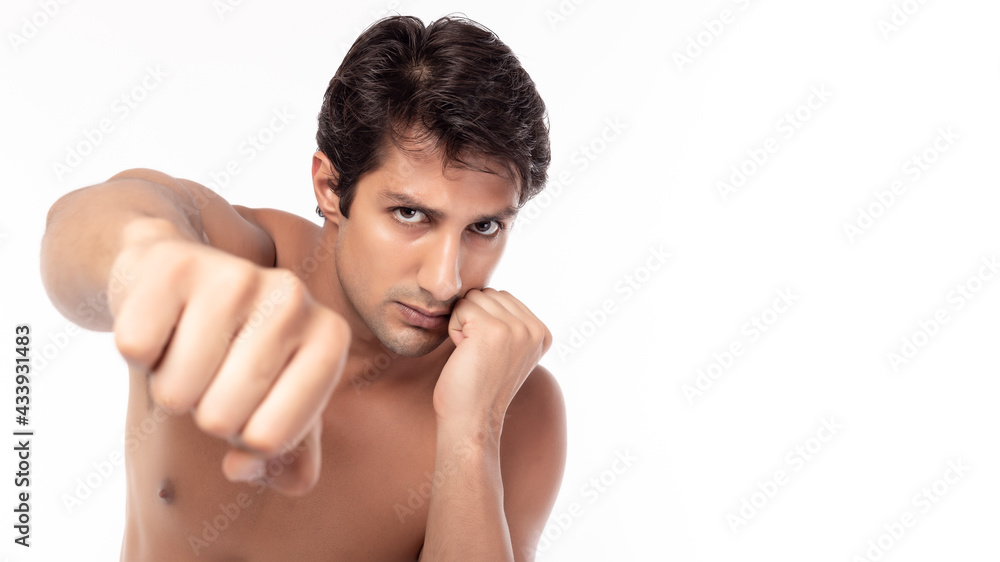 Tough Boxer man showing punch fist isolated on white background Handsome young fighter men punching in studio shot with determined and powerful Sportsman get strength Fitness man exercising Bare chest