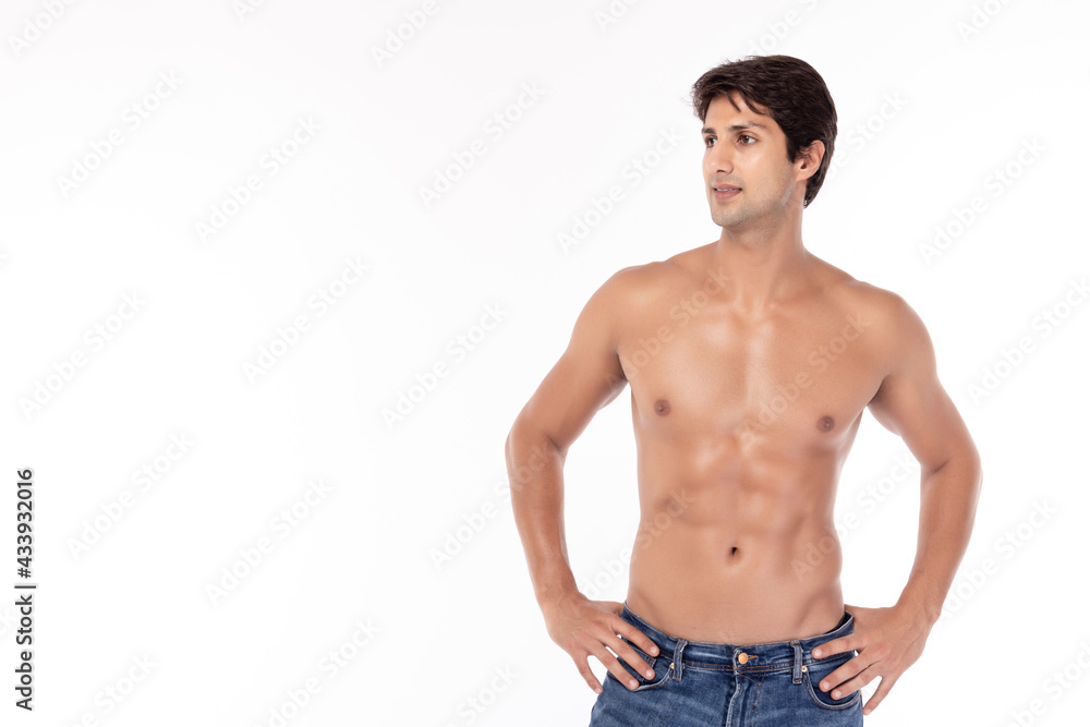 Portrait shirtless strong athletic young man showing six pack abs, Studio shot isolated on white background Copy space Handsome young guy wear blue jeans Men look at space for insert advertisement Portrait shirtless strong athletic young man showing six pack abs, Studio shot isolated on white background Copy space Handsome young guy wear blue jeans Men look at space for insert advertisement
