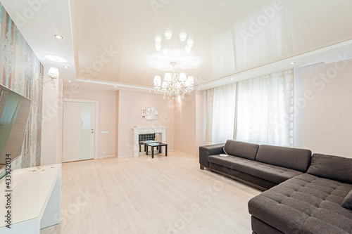 Russia  Moscow- April 28  2020  interior room apartment bright cozy atmosphere. general cleaning  home decoration  preparation of house for sale. living room with sofa. lamp chandelier on the ceiling