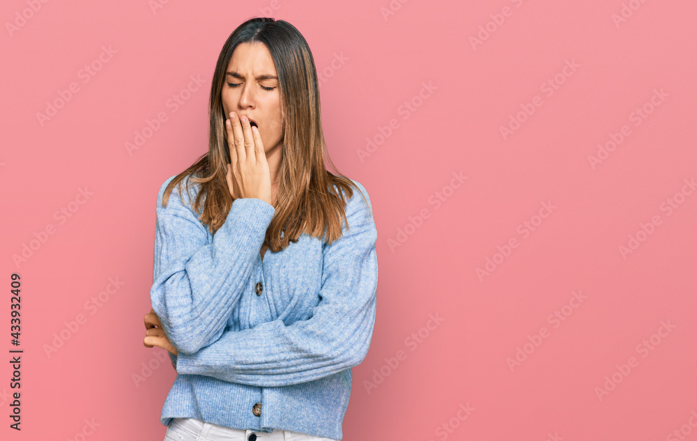 Young woman wearing casual clothes bored yawning tired covering mouth with hand. restless and sleepiness. Young woman wearing casual clothes bored yawning tired covering mouth with hand. restless and sleepiness.