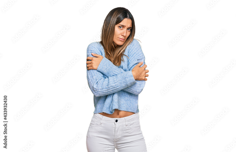 Young woman wearing casual clothes shaking and freezing for winter cold with sad and shock expression on face Young woman wearing casual clothes shaking and freezing for winter cold with sad and shock expression on face