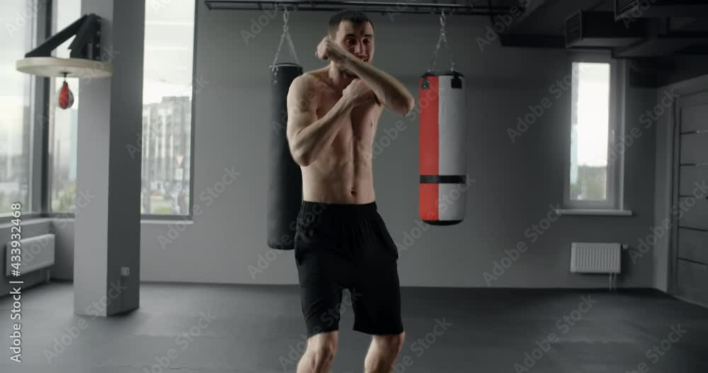 Mixed martial art fighter does shadow boxing to the camera with fast movements, fighter man is fighting with shadow, 4k 60p Prores HQ Mixed martial art fighter does shadow boxing to the camera with fast movements, fighter man is fighting with shadow, 4k 60p Prores HQ