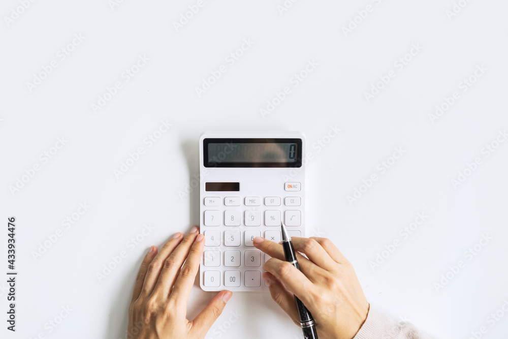 Accountant using calculator on desk office on white background with copy space, Top view - obrazy, fototapety, plakaty 