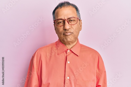 Middle age indian man wearing casual clothes and glasses depressed and worry for distress, crying angry and afraid. sad expression. © Krakenimages.com