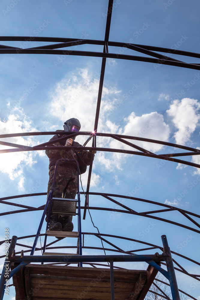 A worker welds metal to the canopy. Technologies