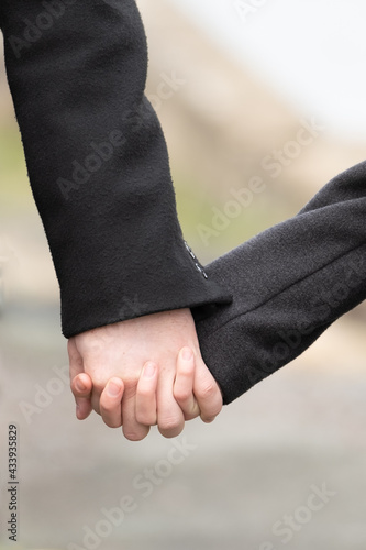 The woman and the man are holding hands.