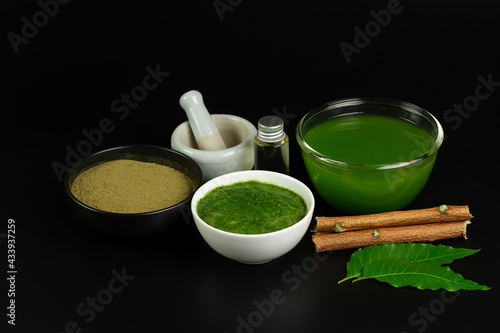 Neem used as ayurvedic medicine on black background. Neem is an excellent moisturizing and contains various compounds that have insecticidal and medicinal properties.