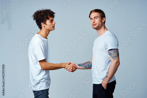 two men friendship shaking hands isolated background