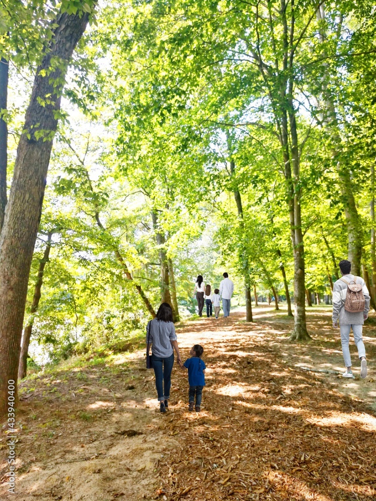 parent and child walking in the park parent and child walking in the park