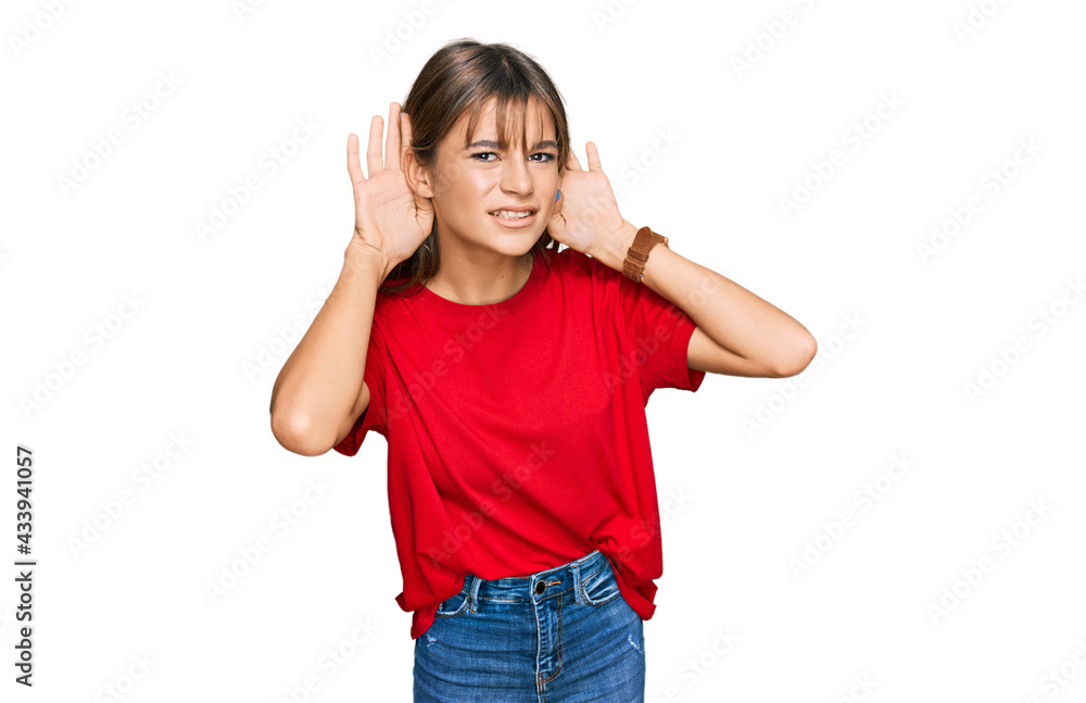 Teenager caucasian girl wearing casual red t shirt trying to hear both hands on ear gesture, curious for gossip. hearing problem, deaf Teenager caucasian girl wearing casual red t shirt trying to hear both hands on ear gesture, curious for gossip. hearing problem, deaf