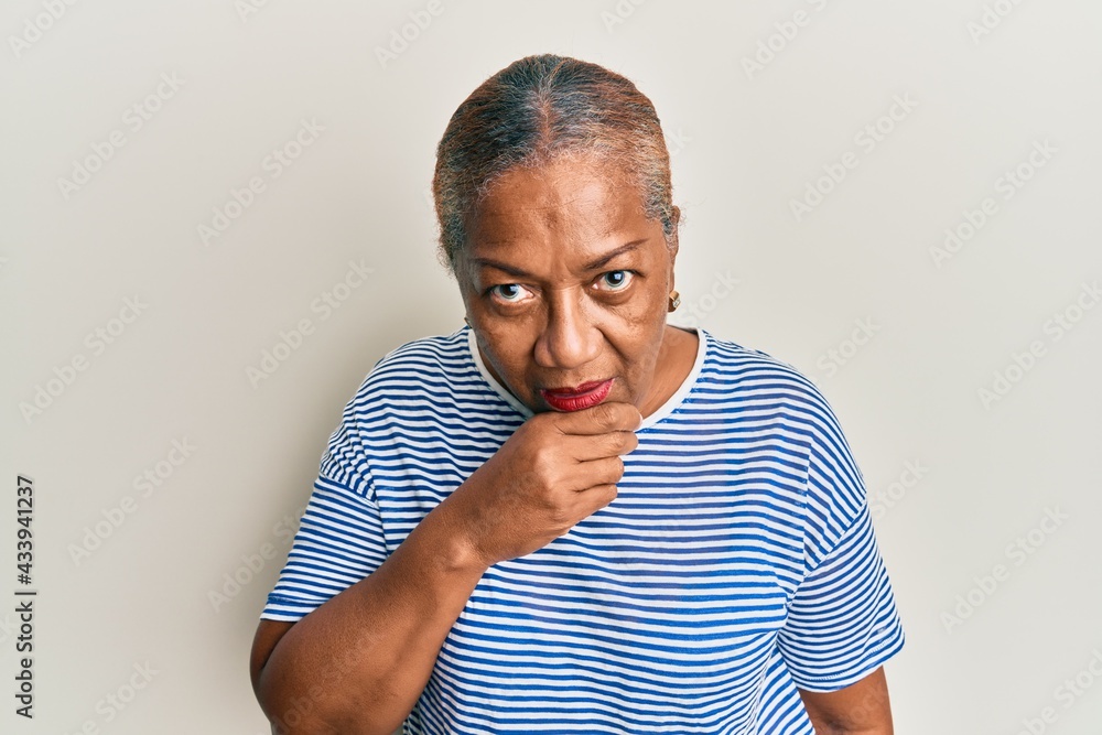 Senior african american woman wearing casual clothes feeling unwell and coughing as symptom for cold or bronchitis. health care concept. Senior african american woman wearing casual clothes feeling unwell and coughing as symptom for cold or bronchitis. health care concept.