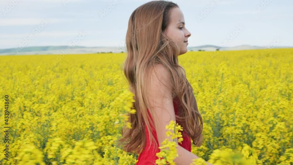 Young girl running through canola field in spring time, with bees following her - slow motion Young girl running through canola field in spring time, with bees following her - slow motion