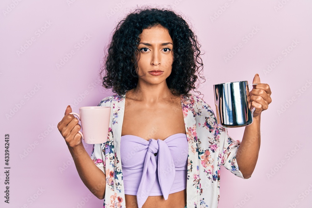 Young latin girl holding cup of coffee and jar of milk depressed and worry for distress, crying angry and afraid. sad expression. Young latin girl holding cup of coffee and jar of milk depressed and worry for distress, crying angry and afraid. sad expression.