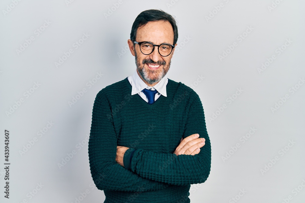 Middle age hispanic man wearing casual clothes and glasses happy face smiling with crossed arms looking at the camera. positive person. Middle age hispanic man wearing casual clothes and glasses happy face smiling with crossed arms looking at the camera. positive person.