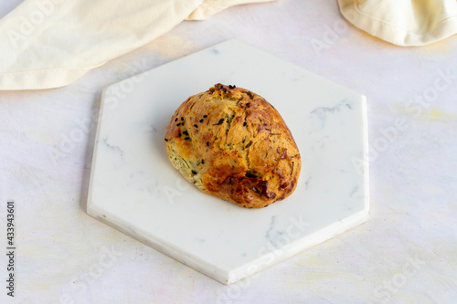 Cheese and dill pastry on a white wooden background. Local name dereotlu ve peynirli poğaça photo