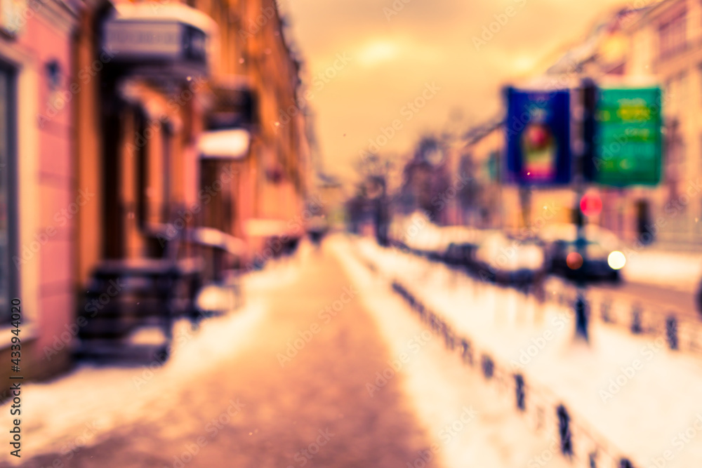 Snowy winter in the big city, the empty street covered with snow and billboard. Defocused image