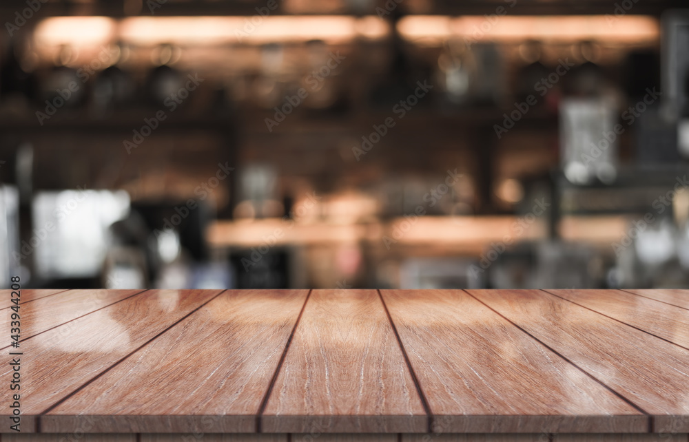 Empty wooden table top with lights bokeh on blur restaurant background. Empty wooden table top with lights bokeh on blur restaurant background.