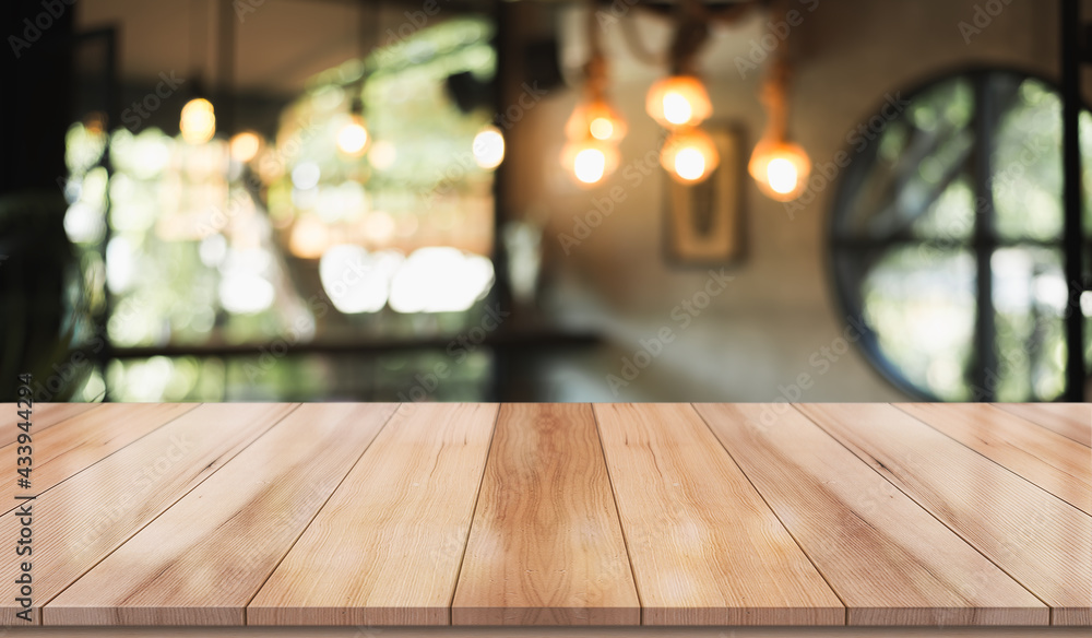 Empty wooden table top with lights bokeh on blur restaurant background. Empty wooden table top with lights bokeh on blur restaurant background.
