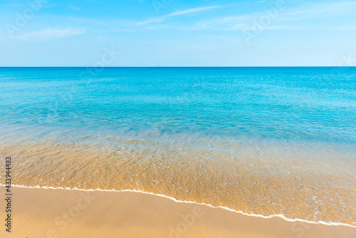 Blue sea water and sand beach with blue sky