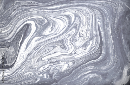 Grey and white marble texture. Liqued ink background.