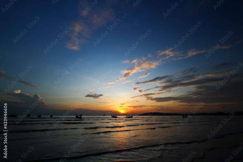 Beautiful silhouette of ship and long tail boat on sea or ocean with blue sky and cloud at sunset, sunrise or twilight time at Krabi, Thailand. Beauty in nature with wave and Transportation concept Beautiful silhouette of ship and long tail boat on sea or ocean with blue sky and cloud at sunset, sunrise or twilight time at Krabi, Thailand. Beauty in nature with wave and Transportation concept