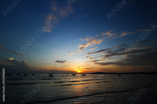 Beautiful silhouette of ship and long tail boat on sea or ocean with blue sky and cloud at sunset  sunrise or twilight time at Krabi  Thailand. Beauty in nature with wave and Transportation concept 