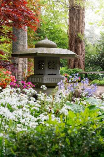 Japanese garden pagoda ornament surrounded by flowers photo