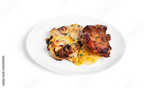 Baked potatoes with cheese and pork steak in white plate isolated on a white background.