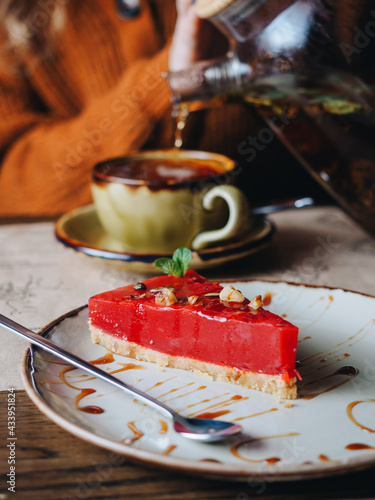 Pelamushi - national georgian pomegranate dessert. With cup of tea photo