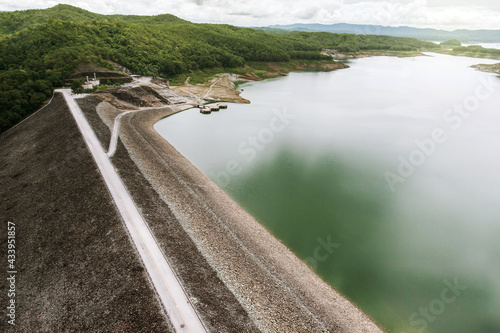Aerial view of a embankment dam and tropical forest.