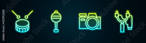 Set line Drum with drum sticks, Rattle baby toy, Photo camera and Slingshot. Glowing neon icon. Vector