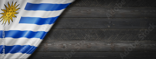 Uruguaian flag on black wood wall banner photo