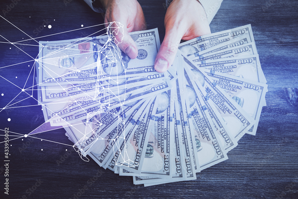 Multi exposure of creative drawing hologram and USA dollars bills and man hands. Start up concept Multi exposure of creative drawing hologram and USA dollars bills and man hands. Start up concept