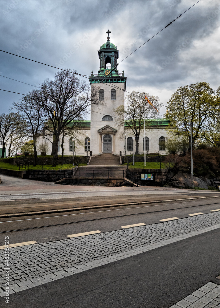Fototapeta premium Carl Johans Kyrka with dark cloud in the background, Gothenburg Sweden