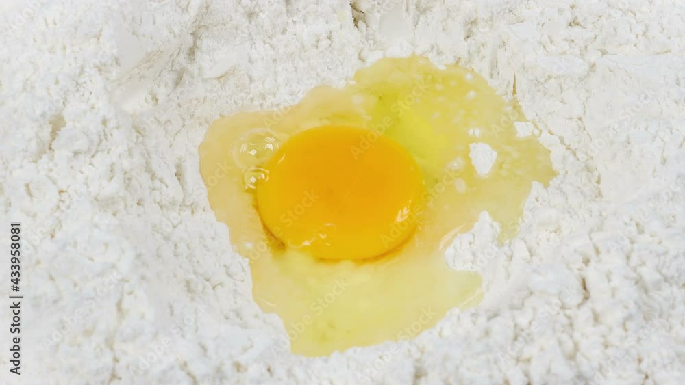 Broken egg on flour, means for making bread, rotation, 4k Broken egg on flour, means for making bread, rotation, 4k