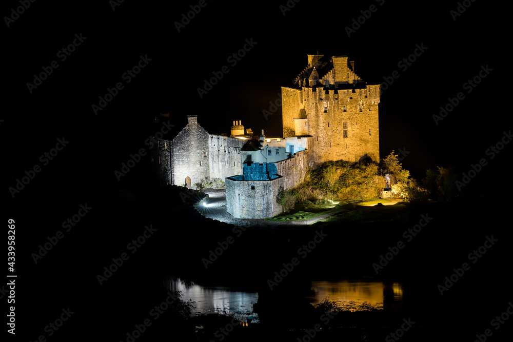 Eilean Donan Castle during a night with nice reflection in water. Long exposure. Dornie in Scotland