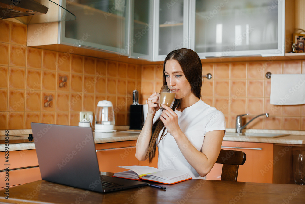 A young girl works at home on a remote site. Distance learning. Stay at home A young girl works at home on a remote site. Distance learning. Stay at home